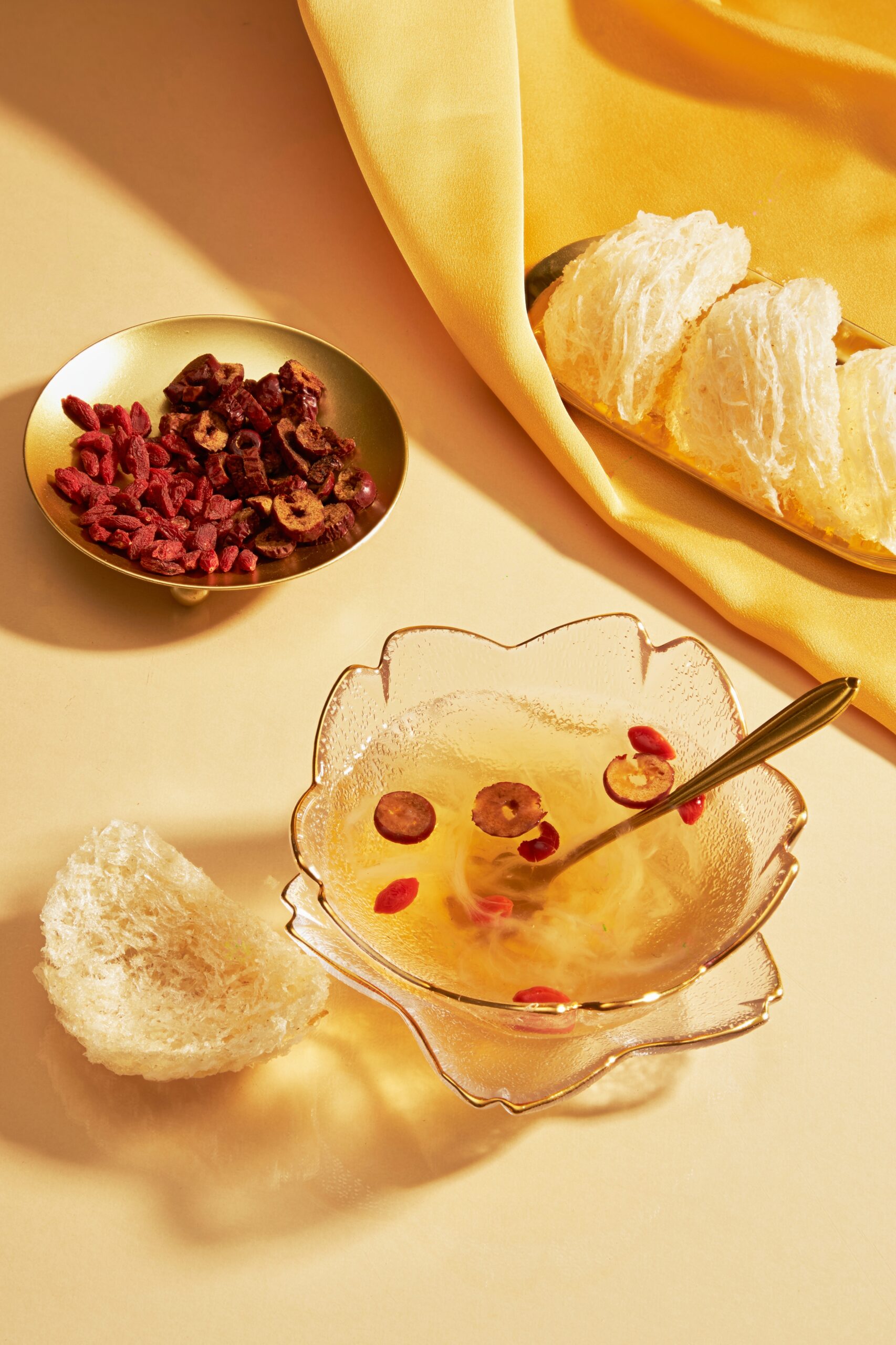 a,dish,of,edible,birds,nest,placed,on,yellow,fabric,